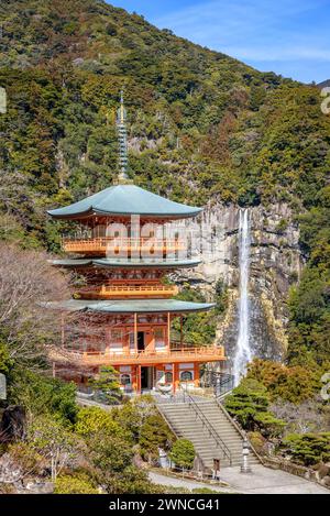 Three story pagoda of Seiganto-ji Tendai Buddhist temple in Wakayama Prefecture, Japan with Nachi Falls in the background Stock Photo