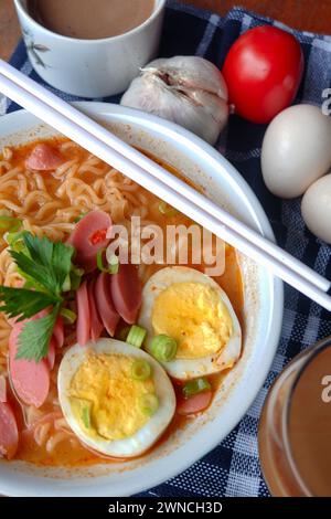 Photo of noodle soup with toppings such as sausages, eggs, and vegetables Stock Photo