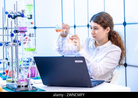 Scientist conducting chemistry experiment Stock Photo