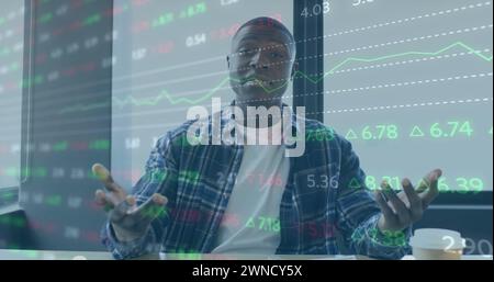 Image of financial data processing over african american businessman working in office Stock Photo