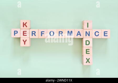 KPI or key performance indicator business strategy and success concept. Crossword puzzle flat lay typography in green background. Stock Photo