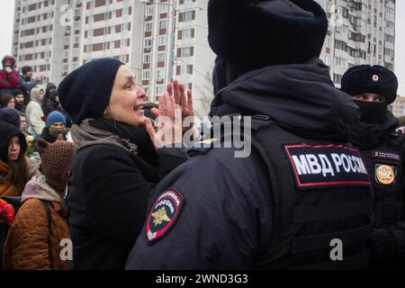 Moscow, Russia. 01st Mar, 2024. A woman is seen surrounded by police officers at the Borisov Cemetery to honor the memory of the late Russian opposition leader Alexei Navalny on Borisovskie Ponds Street. Alexei Navalny was buried at the Borisov Cemetery in Moscow. The funeral service took place at the “Quench My Sorrows” Church in Maryino. Credit: SOPA Images Limited/Alamy Live News Stock Photo