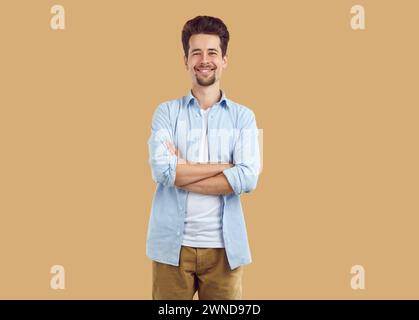 Portrait of smiling man standing with his arms folded Stock Photo