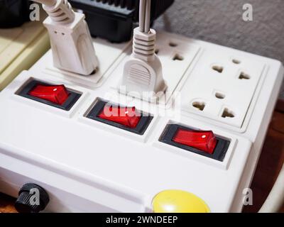 Multiple power socket with connected plugs Stock Photo