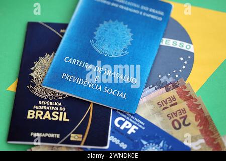 Passport of Brazil and work card with brazilian reais money bills on ...