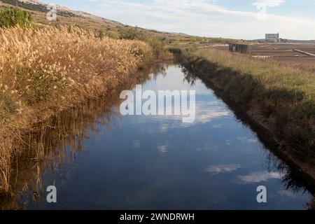 a channel that drains rainwater around the salt pan Stock Photo