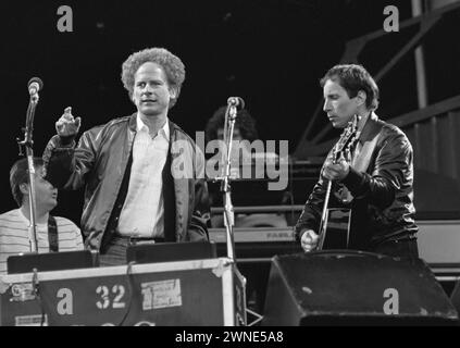 Rotterdam, Netherlands. June 12, 1982.  Simon and Garfunkel (left) performing in Feijenoord Stadium, Rotterdam.  Both on stage, singing performing one of their songs Stock Photo