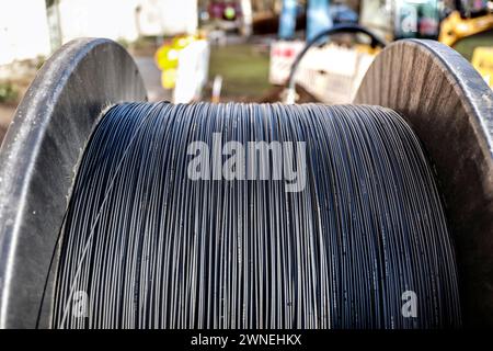 Cable drum with fibre optic cable is lying on a construction site for laying, Berlin, 29.02.2024 Stock Photo