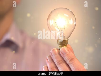 Person holding a light bulb suggesting an idea Stock Photo
