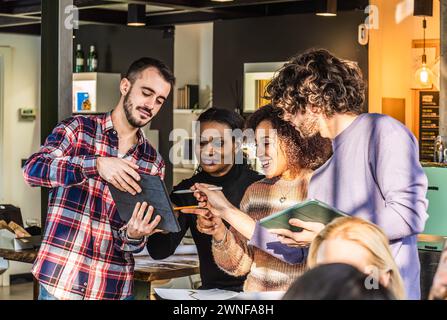 Multicultural Startup Coworkers Collaborating in a Modern Office - Concept of Business Finance Teamwork and Cooperation Stock Photo