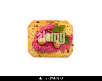 Beet hummus spread on a cracker isolated on white background Stock Photo