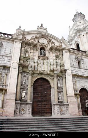 The Basilica Cathedral of Lima on Plaza Mayor or Plaza de Armas. Located in the Historic Centre of Lima, Peru. People and tourists stroll on square. Stock Photo