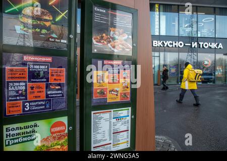 Moscow, Russia. 2nd of March, 2024. Advertising banners are seen at an entrance to 'Vkusno - and tochka' (Eng:'Delicious. Full Stop') fast food restaurant in a residential area of Moscow, Russia Stock Photo