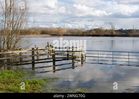 2nd March 2024. Following the warmest February on record in England and Wales, and the wettest February on record in southern England, there is a lot of flooding in parts of Berkshire. Pictured: flooded fields near the River Lodden at Shinfield, Berkshire, England, UK. Extreme rainfall is more common and more intense because of human-caused climate change, since warmer air can hold more water vapour. Stock Photo