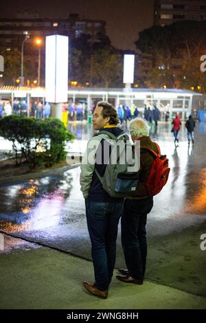 POST MATCH, RAINSTORM, CAMP NOU, BARCELONA FC, 2019: Soaked Barcelona fans hang around the Nou Camp Stadium before heading home after an easy win over a title rival in torrential rain. Photo: Rob Watkins. Barcelona FC played Sevilla FC at Camp Nou, Barcelona on 5 April 2017 and Barca won the game 3-0 with three goals in the first 33 minutes. The entire game was played in the deluge of massive spring rainstorm. Stock Photo