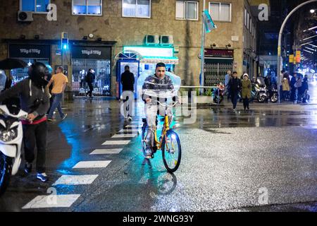 FAN, BICYCLE, RAIN PONCHO, BARCELONA FC, 2019: A cyclist improvises rain protection with a plastic poncho. Soaked Barcelona fans head home an easy win over a title rival in torrential rain. Photo: Rob Watkins. Barcelona FC played Sevilla FC at Camp Nou, Barcelona on 5 April 2017 and Barca won the game 3-0 with three goals in the first 33 minutes. The entire game was played in the deluge of massive spring rainstorm. Stock Photo