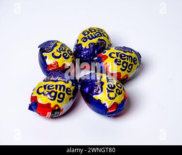 Norwich, Norfolk, UK – March 02 2024. A group of 5 Cadbury Creme Eggs isolated on a plain white background Stock Photo