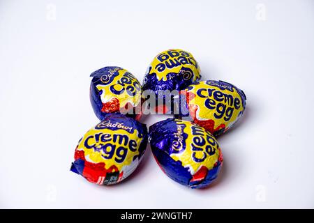 Norwich, Norfolk, UK – March 02 2024. A group of 5 Cadbury Creme Eggs isolated on a plain white background Stock Photo