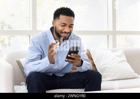 Cheerful young African employee man talking on video call Stock Photo