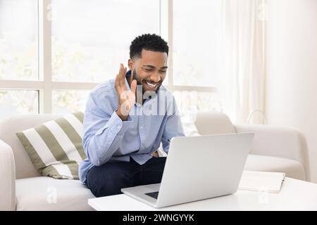 Happy African American student guy enjoying online conversation Stock Photo