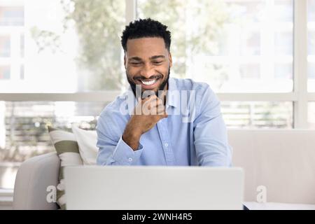 Happy successful African freelancer man working from home Stock Photo