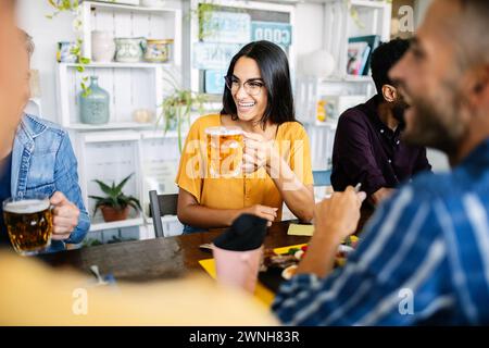 Young group of friends having breakfast or brunch sitting at restaurant table Stock Photo