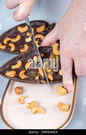 Dark Belgian chocolate Easter egg, filled with cupuaçu jam and cashew nuts 3.  Stock Photo