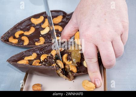 Dark Belgian chocolate Easter egg, filled with cupuaçu jam and cashew nuts 4.  Stock Photo