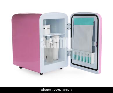 Pink cosmetics refrigerator with skin care products isolated on white Stock Photo