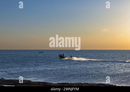 Fishermen on boats in the Mediterranean sea at sunset Israel Stock Photo