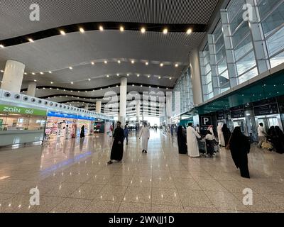 Riyadh , Saudi Arabia - Mar 11 2023 : Passengers traveling through King Khalid International Airport Riyadh Airport - flight  and booking concept Stock Photo