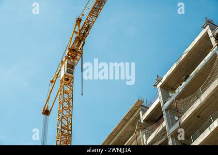 Construction crane working on large construction site Stock Photo