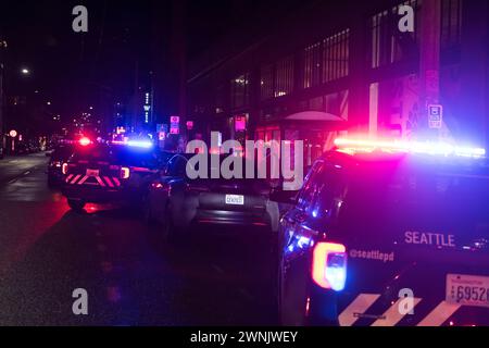 Seattle, USA. 2nd Mar 2024. Just after 11:00pm police rush to Union and Broadway on Capitol Hill after a report of three people shot outside a popular bowling alley. Three victims were located and rushed to Harborview. Credit: James Anderson/Alamy Live News Stock Photo