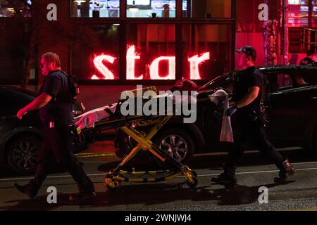 Seattle, USA. 2nd Mar 2024. Just after 11:00pm police rush to Union and Broadway on Capitol Hill after a report of three people shot outside a popular bowling alley. Three victims were located and rushed to Harborview. Credit: James Anderson/Alamy Live News Stock Photo