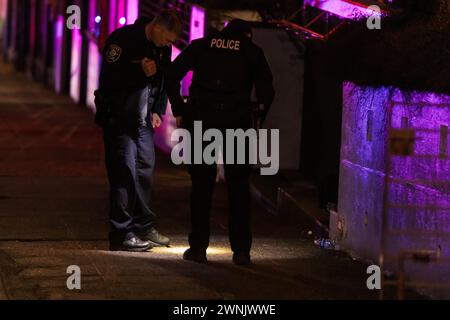 Seattle, USA. 2nd Mar 2024. Just after 11:00pm police rush to Union and Broadway on Capitol Hill after a report of three people shot outside a popular bowling alley. Three victims were located and rushed to Harborview. Credit: James Anderson/Alamy Live News Stock Photo