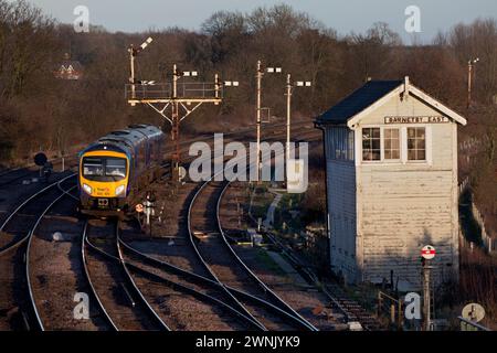 First Transpennine Express Siemns Desiro class 185 train 185101 passing Barnetby east signal box, Lincolnshire with a mechanical bracket signal behind Stock Photo