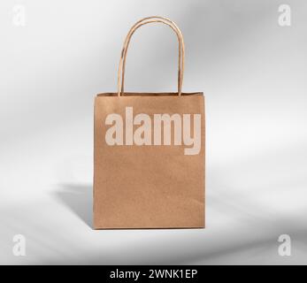 Kraft paper bag with handles, brown gift package, craft pack. Stock Photo