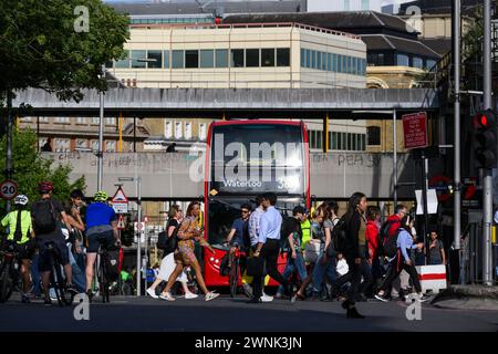 Pedestrians using a pelican crossing to cross Tooley Street during the evening rush hour. Tooley Street, London, UK.  17 Jul 2023 Stock Photo