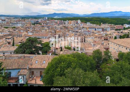 GIRONA, SPAIN - MAY 14, 2017: It is an aerial view of the old town and the surrounding mountains in an overcast spring evening. Stock Photo