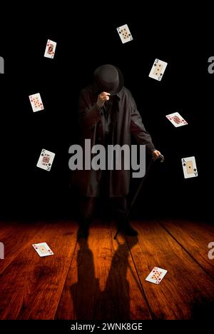 magician with playing cards floating around him Stock Photo