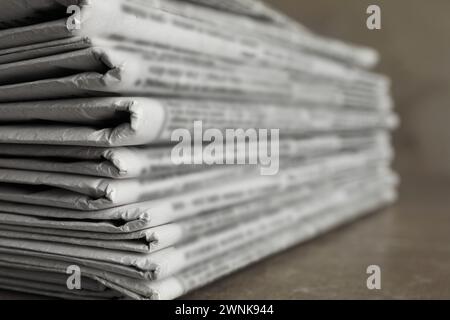 Stack of newspapers on marble table, closeup. Journalist's work Stock Photo