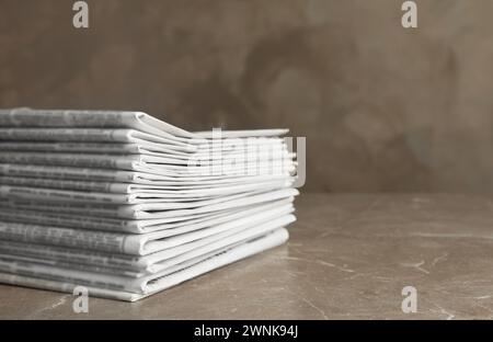 Stack of newspapers on marble table. Journalist's work Stock Photo