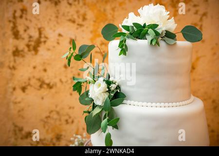 Wedding day details of preparation and reception, white dress with cute flower details and eucaliptus decoration. Stock Photo