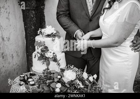Wedding day details of preparation and reception, white dress with cute flower details and eucaliptus decoration. Stock Photo
