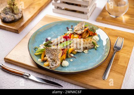 Grilled fish fillet with vegetables on the restaurant table Stock Photo