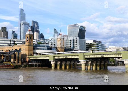 Cannon Street railway bridge and station with the skyscrapers of the City of London financial district in the background.  Cannon Street railway bridg Stock Photo