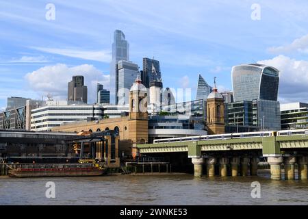 Cannon Street railway bridge and station with the skyscrapers of the City of London financial district in the background.  Cannon Street railway bridg Stock Photo