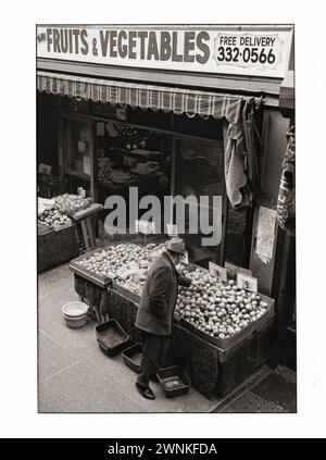 A mid 1970s photos of a man shopping for fruits and vegetables at a market on Brighton Beach avenue in Brighton Beach, Brooklyn, New York. Stock Photo