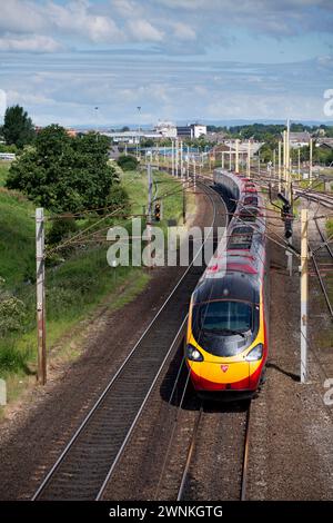 Virgin Trains west coast Pendolino train  passing Carlisle Upperby on the west coast mainline in Cumbria Stock Photo