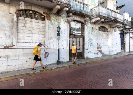 Mother and son walking on the streets in the historic old town of Panama City, passing beautiful building facades, Panama Stock Photo